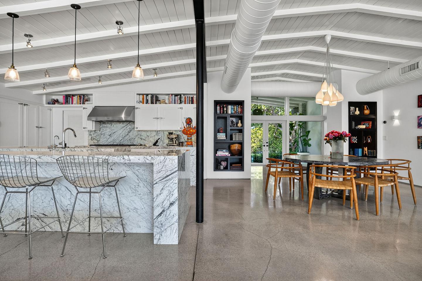 Kitchen with marble island and dining room
