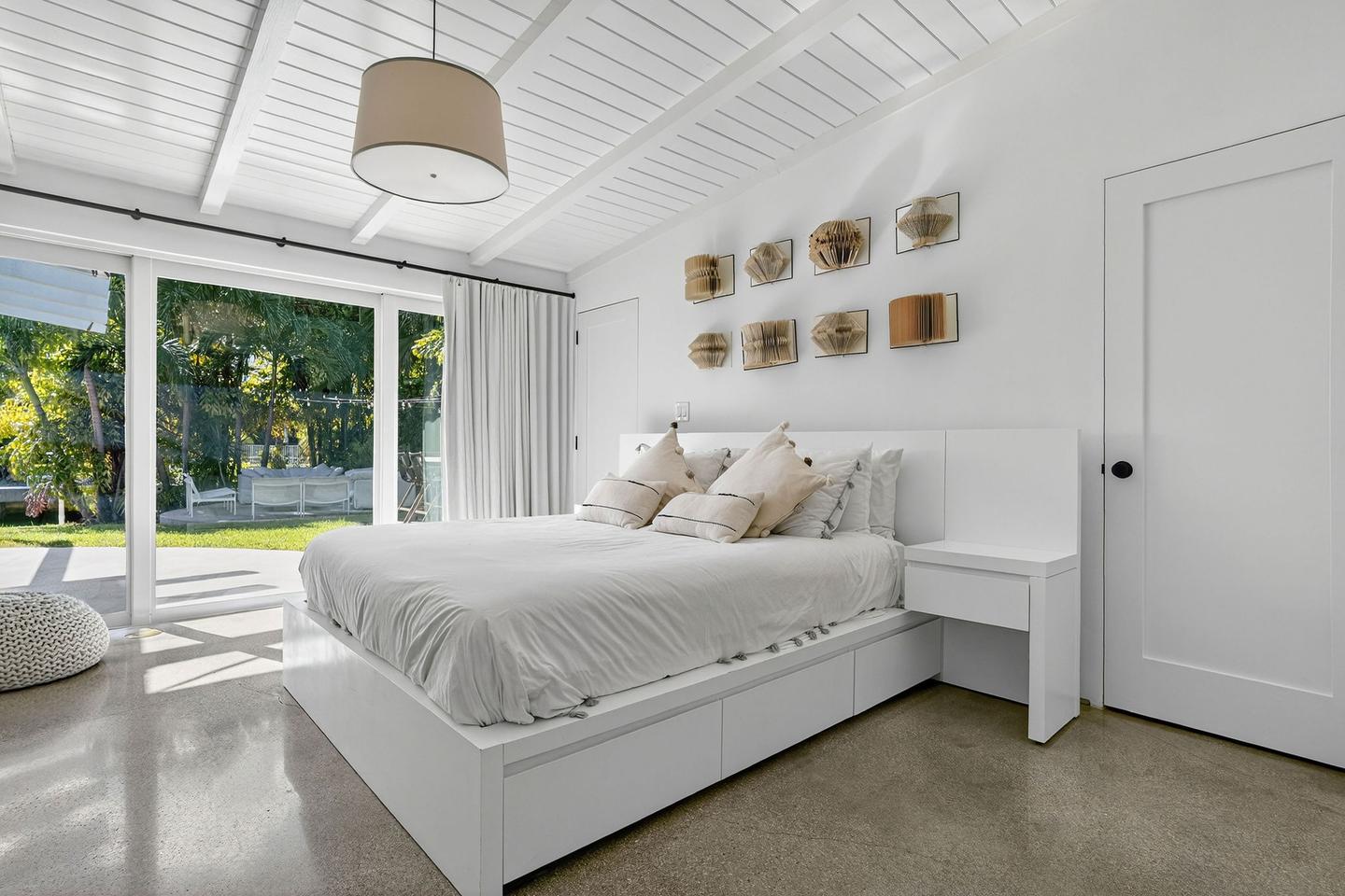 Second bedroom with vaulted ceiling and garden view