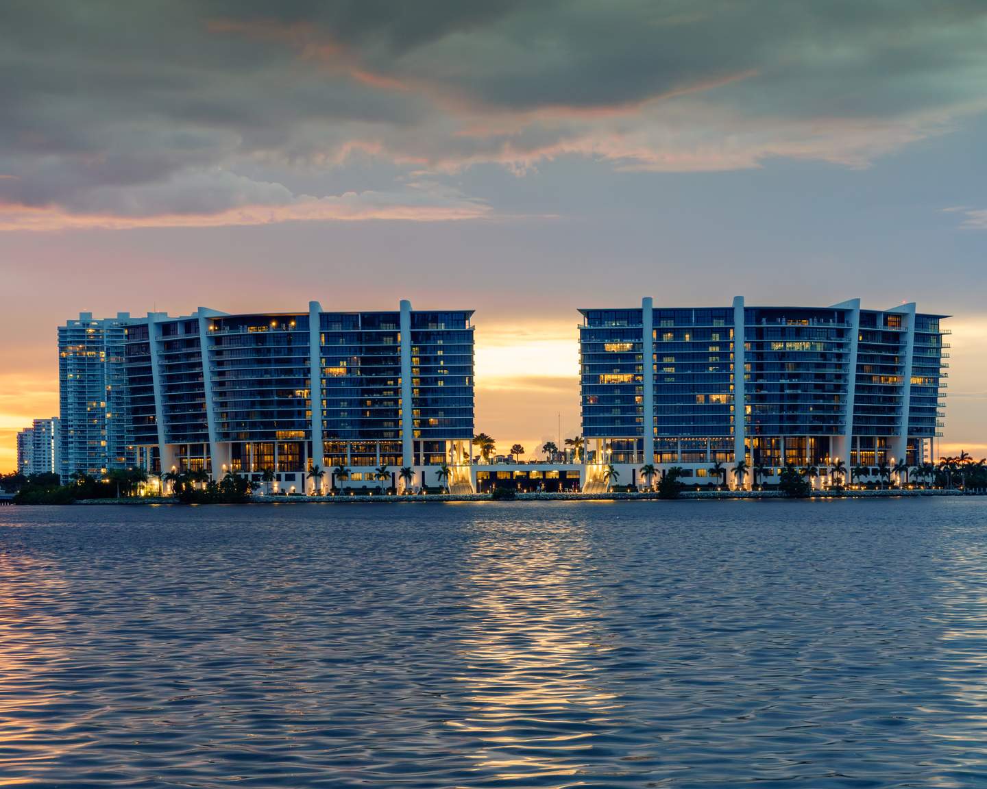 Twilight exterior — waterfront high-rise at sunset