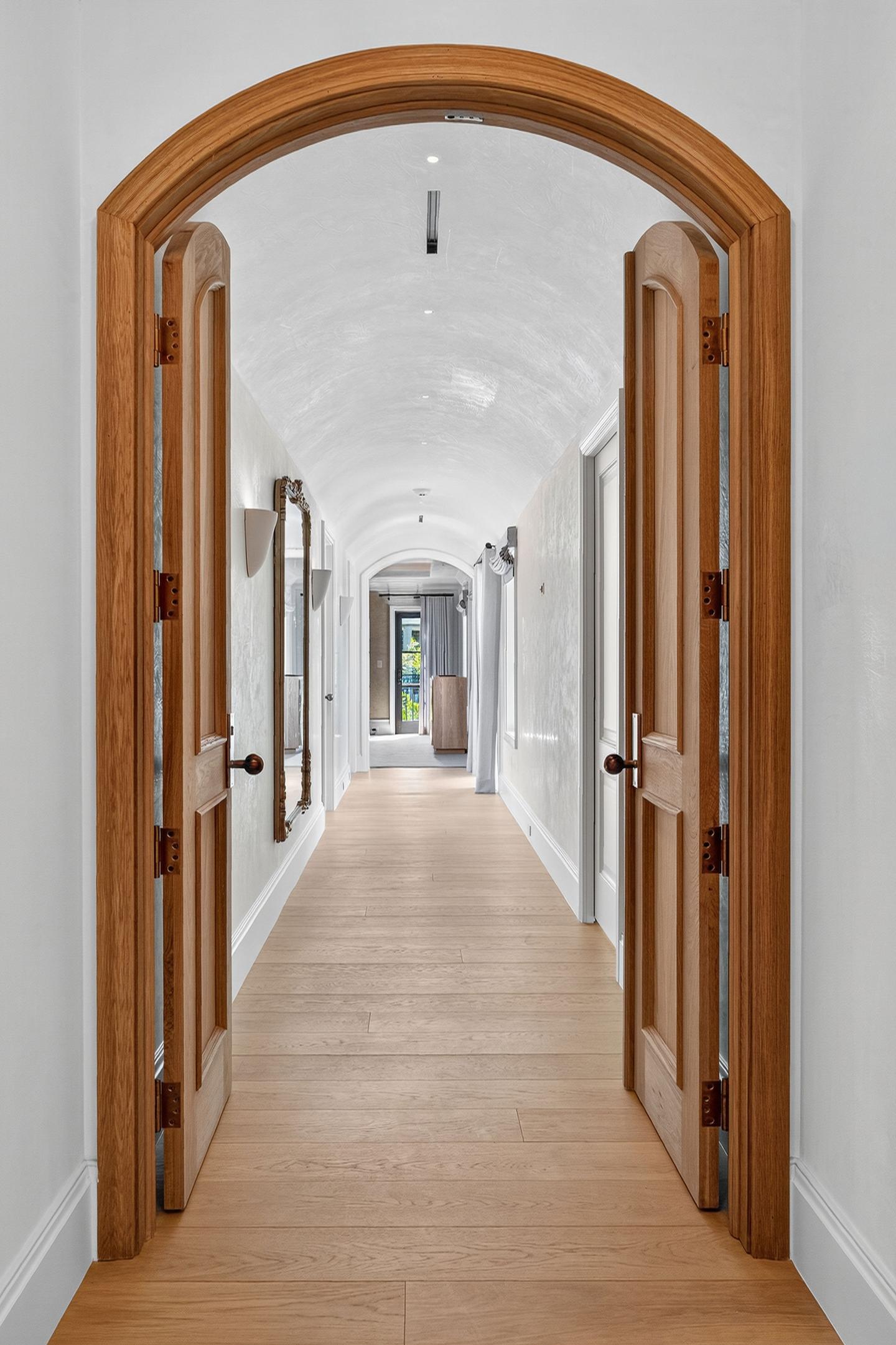 Arched hallway through oak doors