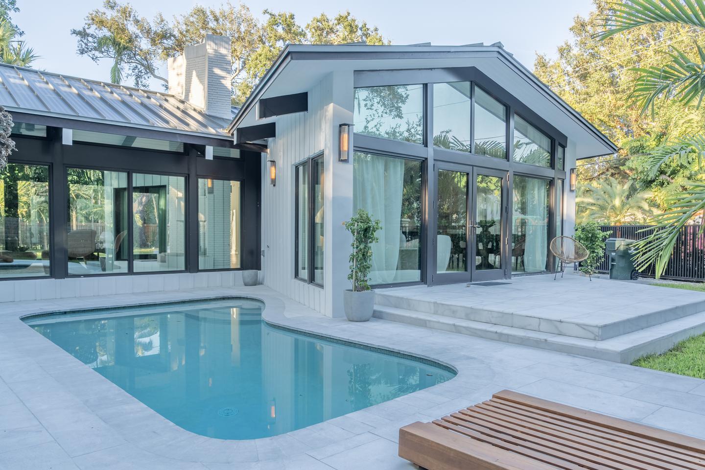 Full pool and glass rear elevation at dusk