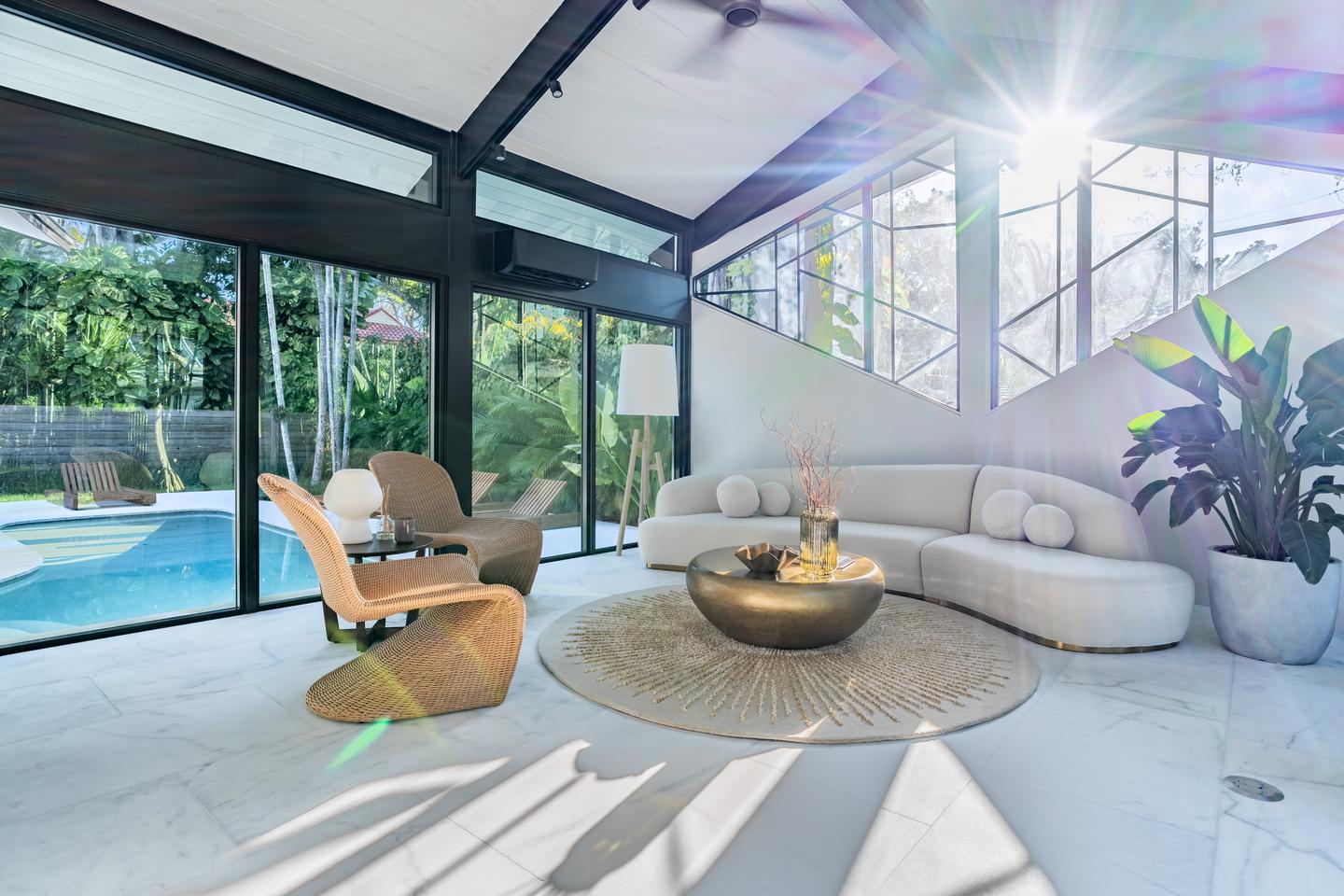Glass-walled living area overlooking pool