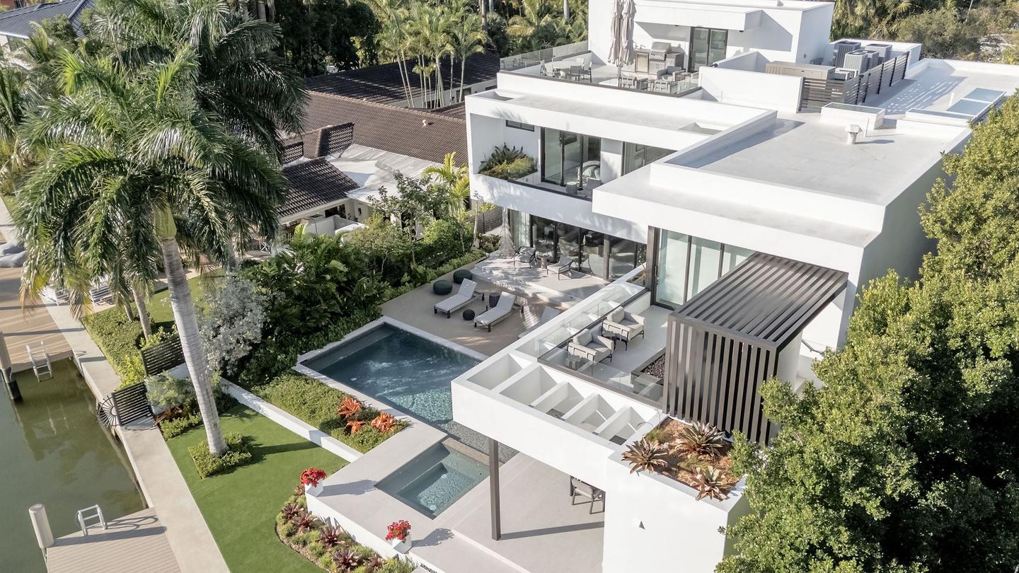 Twilight aerial of luxury waterfront residence