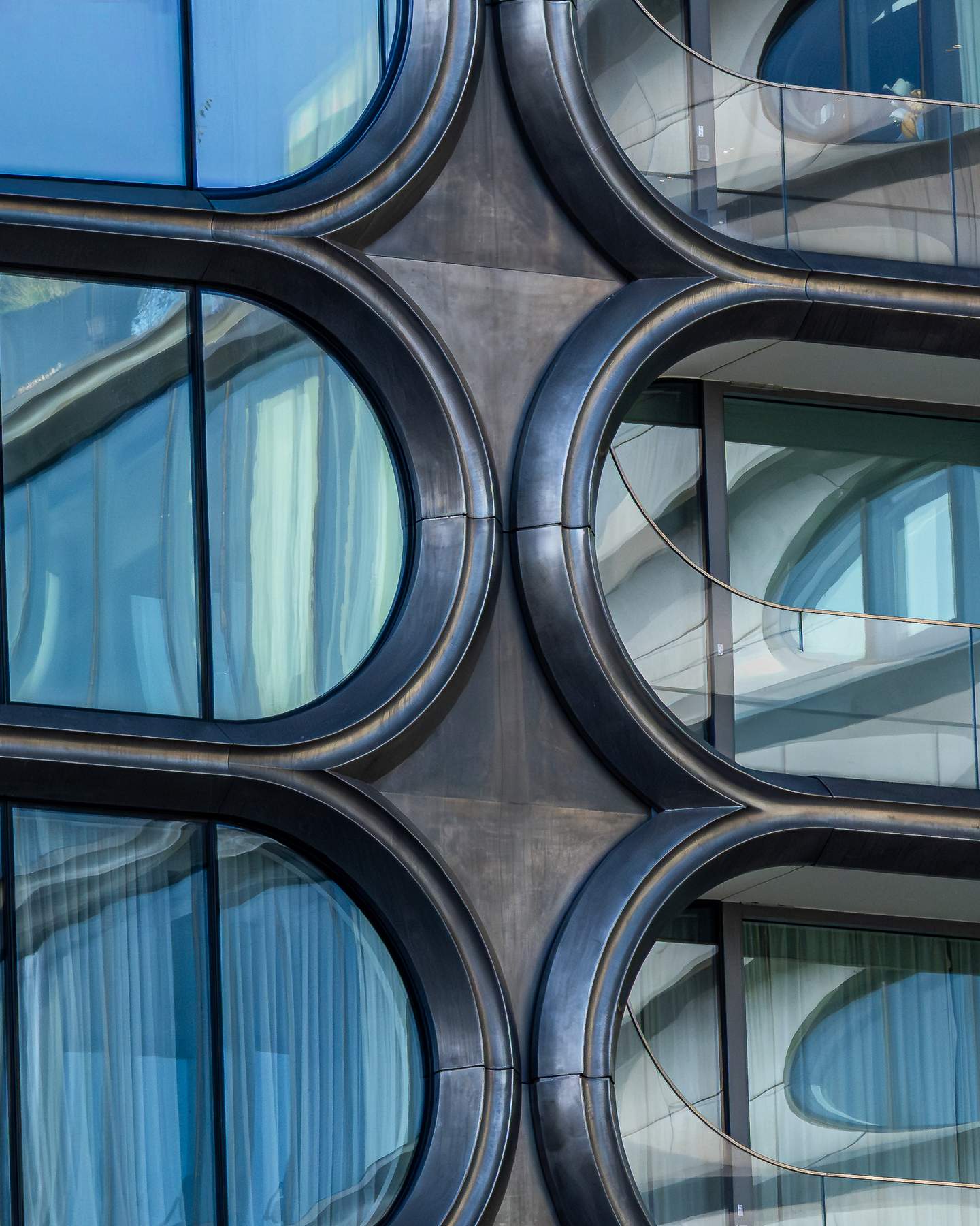 520 West 28th Street, Chelsea - Zaha Hadid Architects, completed posthumously in 2017. Detail of the interlocking circular balcony framing system, dark bronze structural rings interlocking in a pattern simultaneously geometric and biological