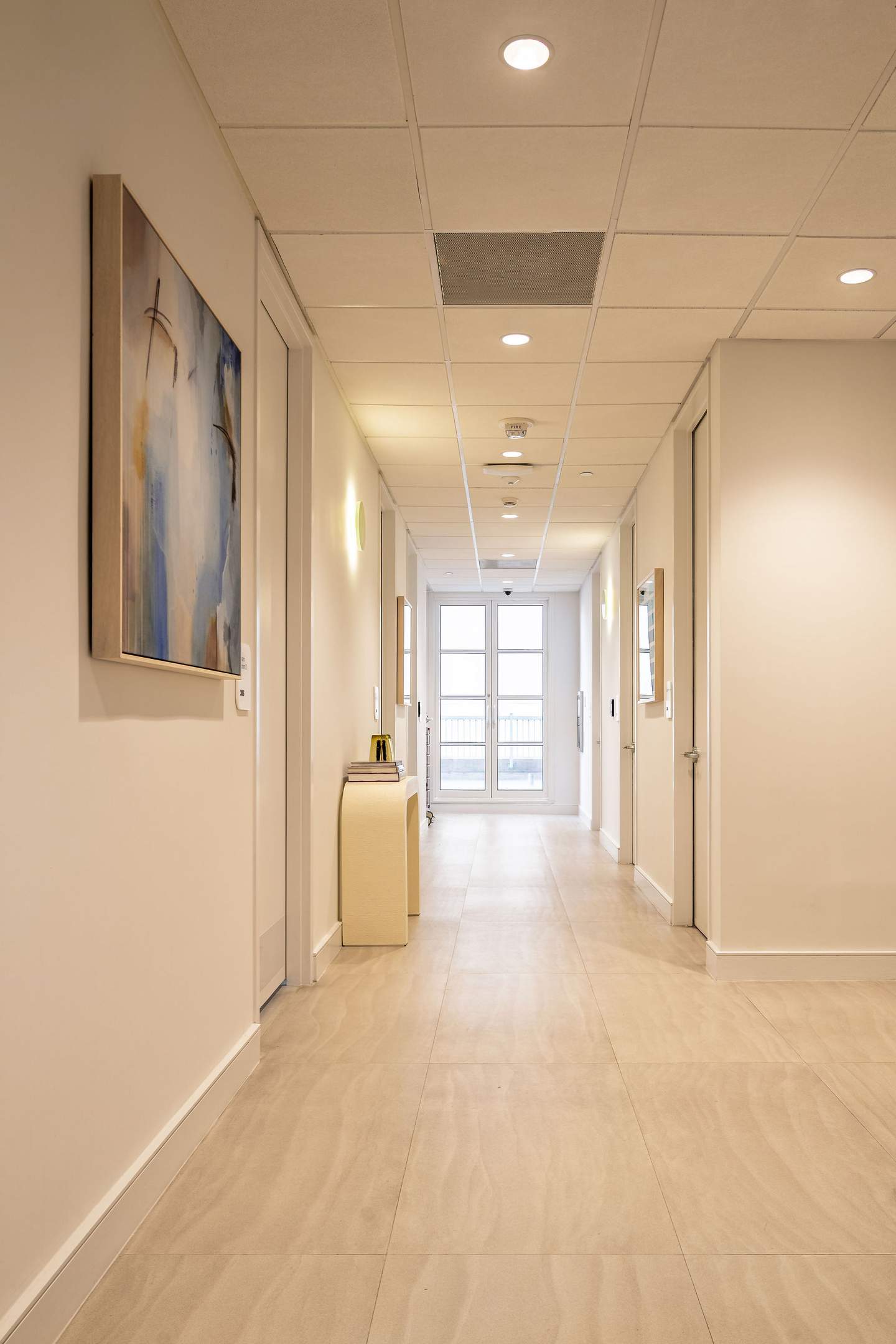 Long clinical corridor with curated artwork