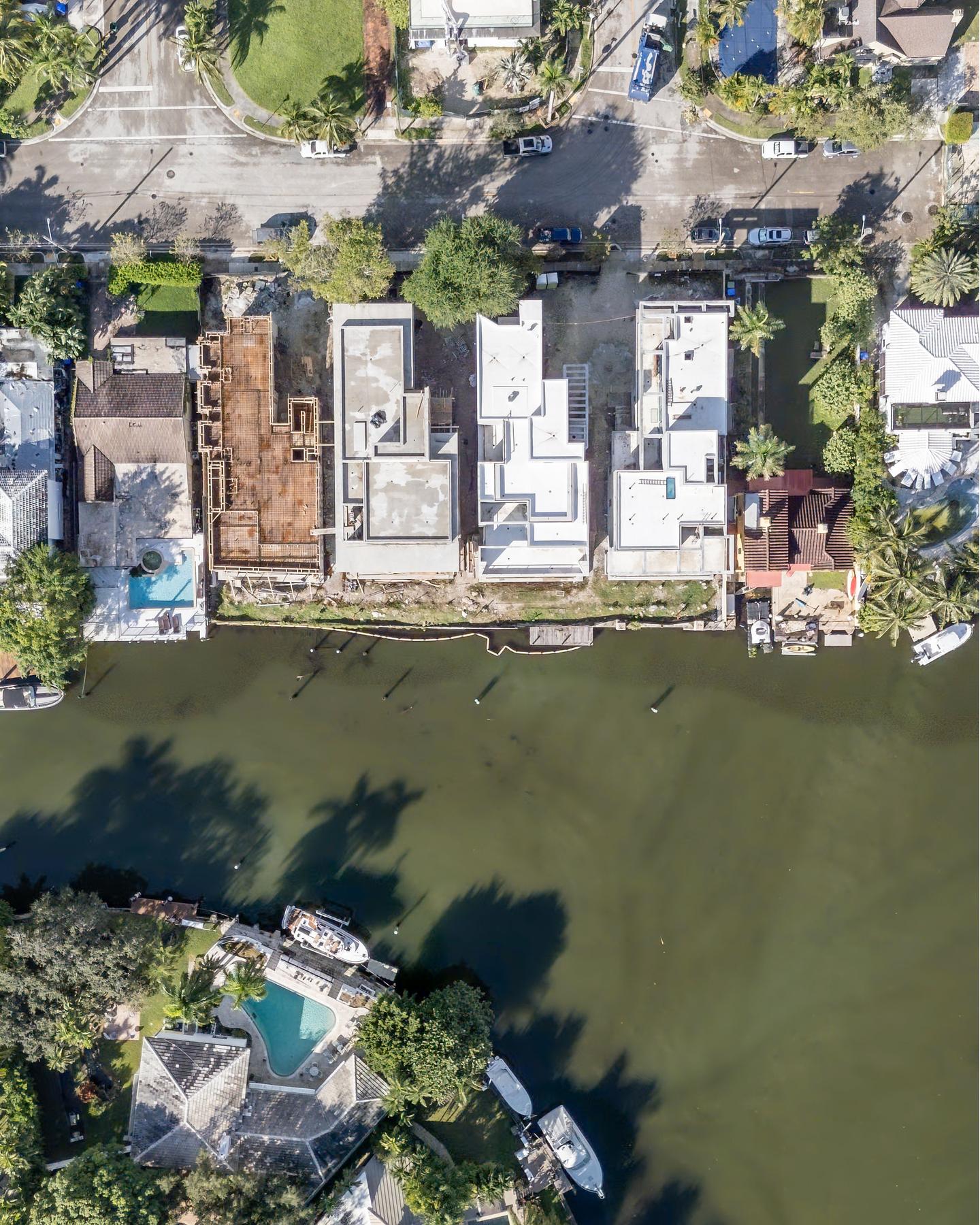 High aerial — full site plan with canal frontage and neighboring properties